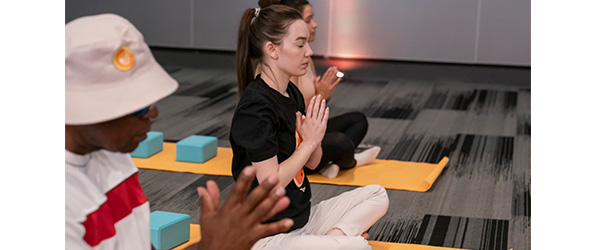 IGS Energy employees participating in yoga at a company event)