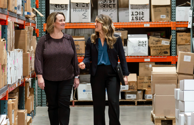 IGS Energy employee discusses solutions with a business person in their warehouse