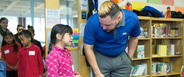 IGS employee talking with school children