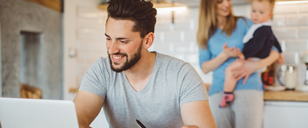 Man at laptop looking at earcly termination fees on energy plans