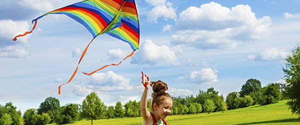 Girl flying a kite in the park