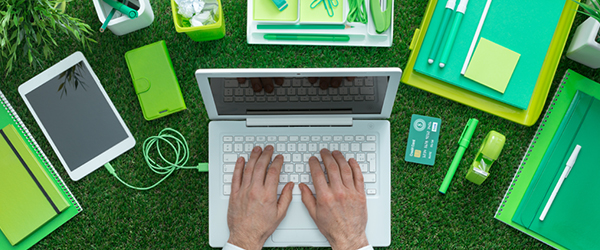 Laptop, tablet, notebooks and desk material outside on grass)