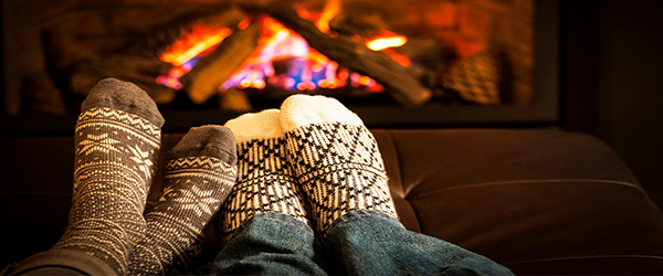 Socked feet warming by a fire)