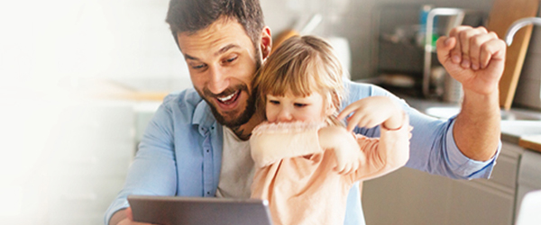 Father and daughter on laptop